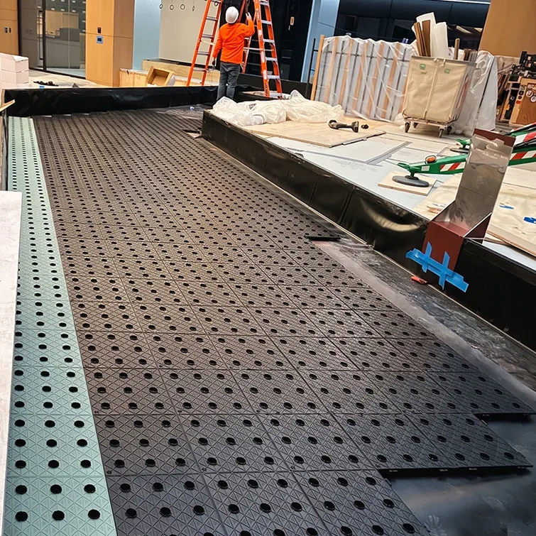 PhytoMat tiles being installed in a large commercial space